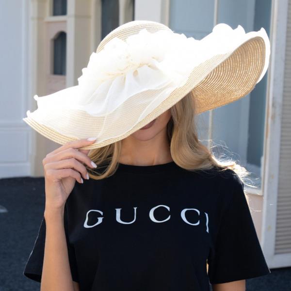 PAPER STRAW FLOPPY SUN HAT WITH SOFT WAVY BRIM AND LAYERED ORGANZA FLORAL TRIM DETAIL